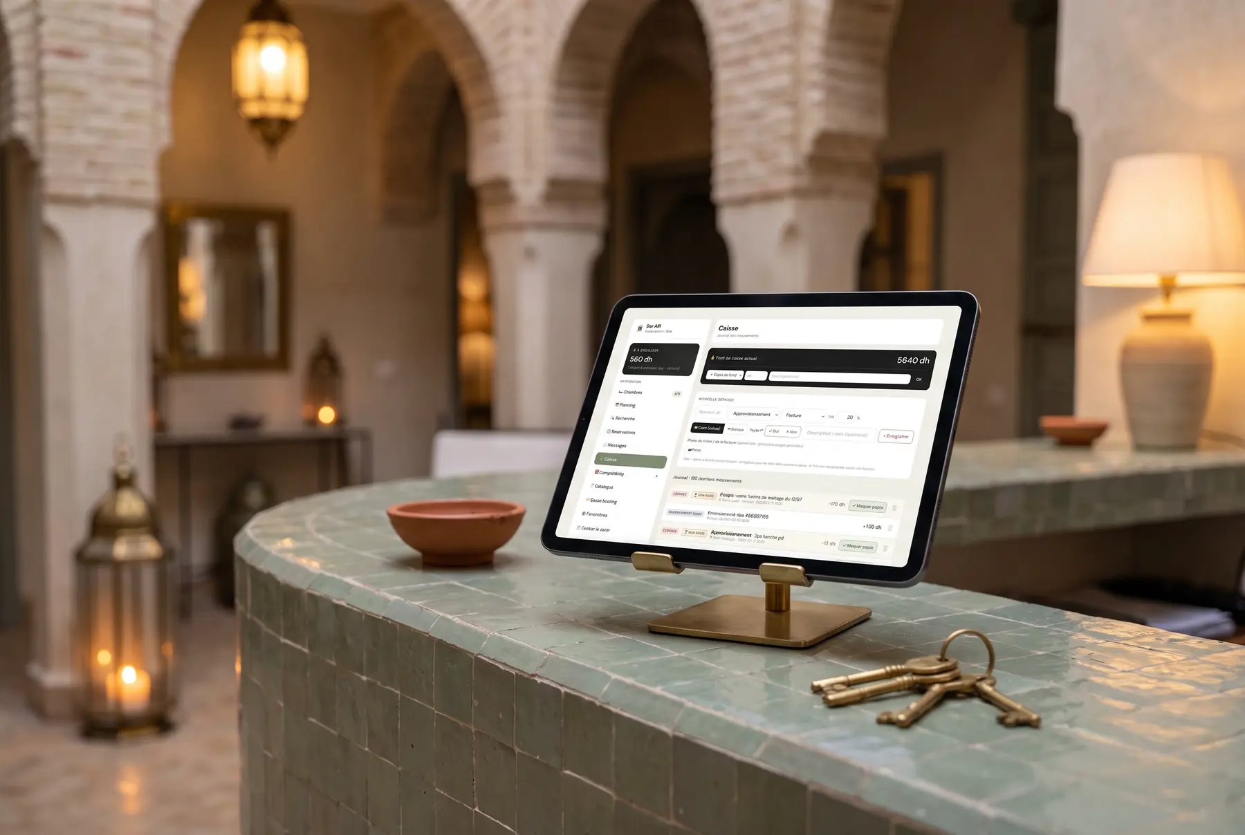 Riad Admin sur iPad, posé sur un comptoir en zellige d'un riad